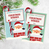 Printable Christmas candy cane holder tags featuring Santa in a chimney with ‘Sending You Sweet Christmas Wishes’ message. Includes space to write names and add candy canes, perfect for kids’ holiday gifts or festive classroom handouts.