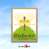 Manualidad cristiana de Pascua para niños con cruz de madera y huellas de manos en forma de alas de ángel. Fondo verde vibrante y la frase “Él ha resucitado” en estilo caligráfico. Actividad perfecta para enseñar el verdadero significado de la Pascua en clases religiosas, preescolar o en casa. Plantilla descargable en formato JPG 8.5x11 y A4 lista para imprimir y pintar.