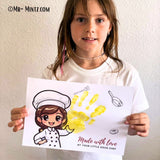 Father’s Day handprint craft with a smiling cartoon boy chef and the message “Made with love by your little sous-chef.” A bright orange handprint appears next to the child character, surrounded by kitchen utensils. Printable JPG template for Father’s Day preschool crafts.