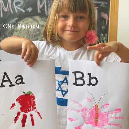 Child holding handmade alphabet crafts for A and B using handprint art. Fun educational project for preschool or kindergarten to learn letters and numbers with printable templates.