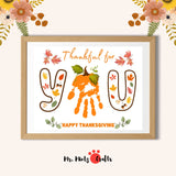 Thanksgiving handprint craft for kids with ‘Thankful for You’ message, featuring autumn-themed letters, fall leaves, and a pumpkin stem, perfect as a keepsake for family or classroom activities.