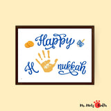 Happy Hanukkah printable with a child's handprint, dreidel, and coins, ideal for a personalized holiday craft or festive decor.