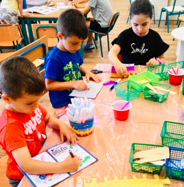 Preschool and kindergarten kids creating printable crafts and art projects at a classroom table — coloring, cutting, and building hands-on activities from Mr. Mintz. Fun and educational DIY crafts for children and teachers across the U.S.